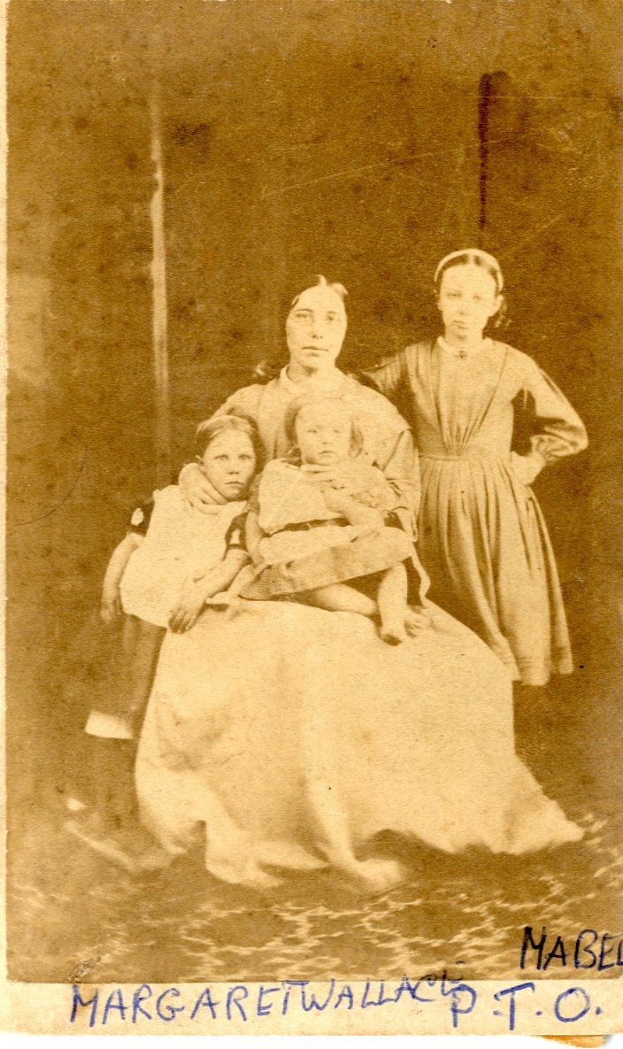 Old photograph showing a woman and three children